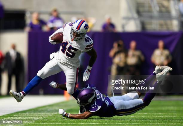 Marcus Murphy of the Buffalo Bills is knocked out of bounds by Mike Hughes of the Minnesota Vikings in the first half of the game at U.S. Bank...