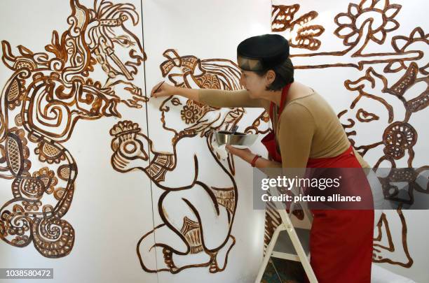 Chocolate artist Dr. Grit Wendelberger restoring her work 'Legende von der Erschaffung der Welt' in her studio in Halle, Germany, 24 August 2016. The...