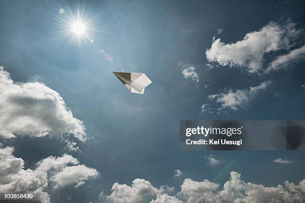 a paper airplane. - avión de papel fotografías e imágenes de stock