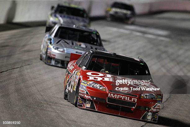 Tony Stewart, driver of the Office Depot/Old Spice Chevrolet, leads Carl Edwards, driver of the Aflac Ford, Jimmie Johnson, driver of the...