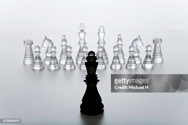 queen of chess that stands in front of enemy - queen chess piece stock-fotos und bilder