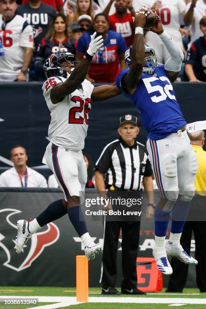 Alec Ogletree of the New York Giants intercepts the ball intended for Lamar Miller of the Houston Texans in the fourth quarter at NRG Stadium on...