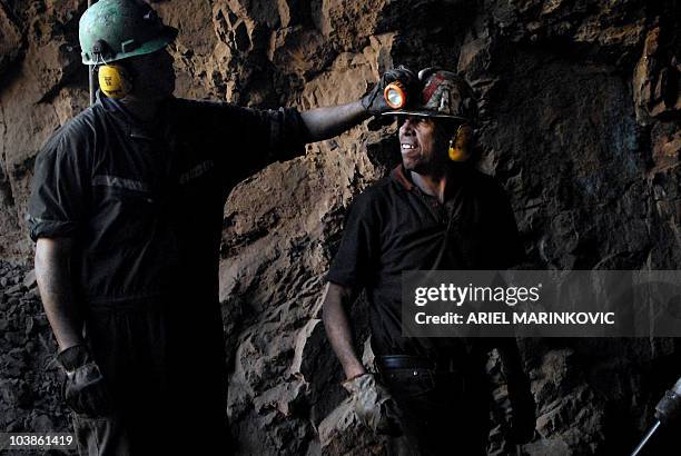 By Moises Avila Roldan Miner Cristian Ulloga switches on the lamp in the helmet of his father Luis before going dong the shaft of the San Javier...