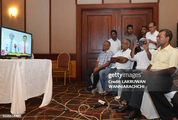 Former President of the Maldives Mohamed Nasheed watches a speech by Maldivian presidential candidate Ibrahim Mohamed Solih on TV at a hotel in...