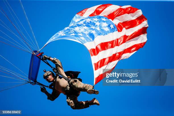 Skydiver with the American Flag in tow jumps to the field halftime of the game between the Kansas City Chiefs and the San Francisco 49ers at...