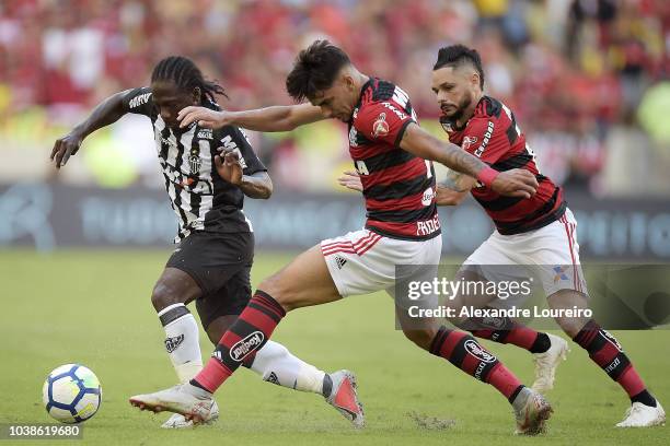 Lucas Paqueta and Para of Flamengo struggles for the ball with Yimmi Chara of Atletico-MG during the match between Flamengo and Atletico-MG as part...