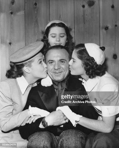 Spanish pianist Jose Iturbi is surrounded by young ladies in the MGM musical film 'The Birds and the Bees', aka 'Three Daring Daughters', 1947. From...