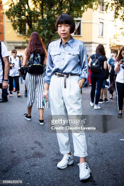Angelica Cheung, wearing light blue shirt, white pants and Tods white sneakers, is seen before the Giorgio Armani show, during Milan Fashion Week...