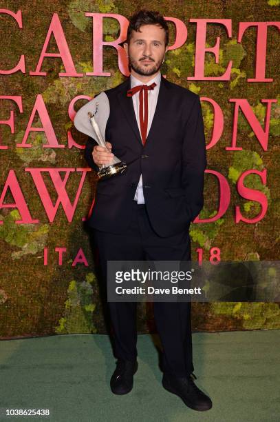 Gilberto Calzolari, winner of the Franca Sozzani GCC Award for Best Emerging Designer, poses backstage at The Green Carpet Fashion Awards Italia 2018...