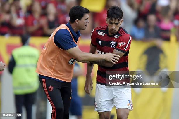 Lucas Paqueta of Flamengo talks with head coach's Mauricio Barbieri after scored a goal during the match between Flamengo and Atletico-MG as part of...