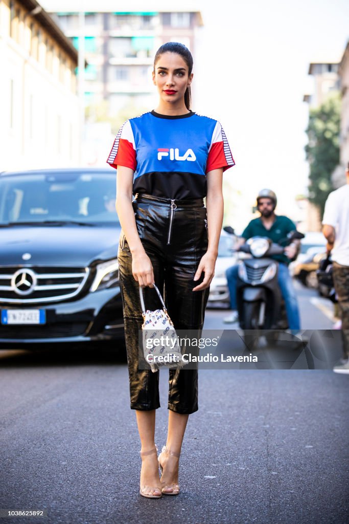 Jessica Kahawaty, wearing Fila tshirt, Fendi bag and black leather ...