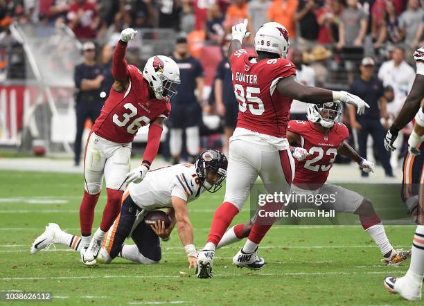 Bene Benwikere, Budda Baker and Rodney Gunter of the Arizona Cardinals celebrate after getting a sack on Mitchell Trubisky of the Chicago Bears...