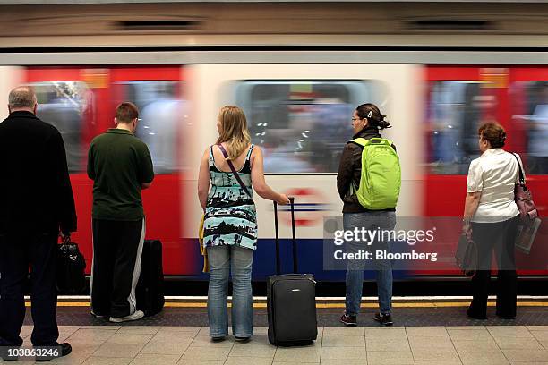Passengers wait to board a Tube train on a London Underground station plaform in London, U.K., on Monday, Sept. 6, 2010. London's 3.5 million Tube...