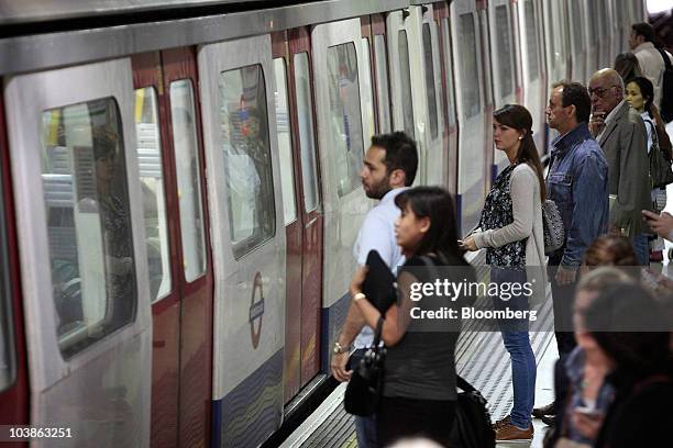 London Underground passengers wait for a Tube train on a platform in London, U.K., on Monday, Sept. 6, 2010. London's 3.5 million Tube travelers face...