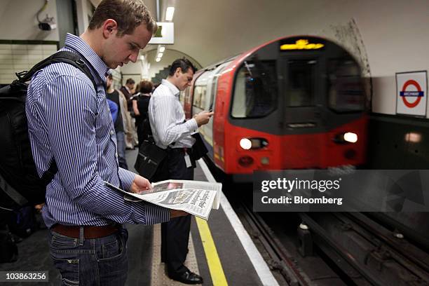 Passengers wait for a Tube train on a London Underground platform in London, U.K., on Monday, Sept. 6, 2010. London's 3.5 million Tube travelers face...