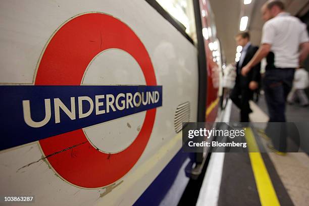 Passengers board a Tube train on the London Underground in London, U.K., on Monday, Sept. 6, 2010. London's 3.5 million Tube travelers face...