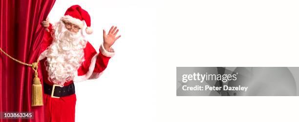 pantomime father christmas with red curtain - santa claus stock pictures, royalty-free photos & images