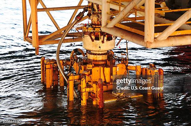 In this handout image provided by the U.S. Coast Guard, the damaged blow out preventer along with the Lower Marine Riser Package cap from the...