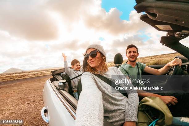 family on a road trip - convertible car stock pictures, royalty-free photos & images