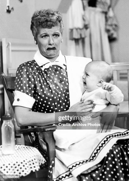 American actress Lucille Ball finds motherhood overwhelming in 'No Children Allowed', an episode of the television show 'I Love Lucy', 1953. The...