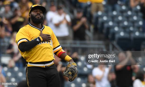 Josh Harrison of the Pittsburgh Pirates acknowledges the crowd as he is removed from the game against the Milwaukee Brewers in the eighth inning at...