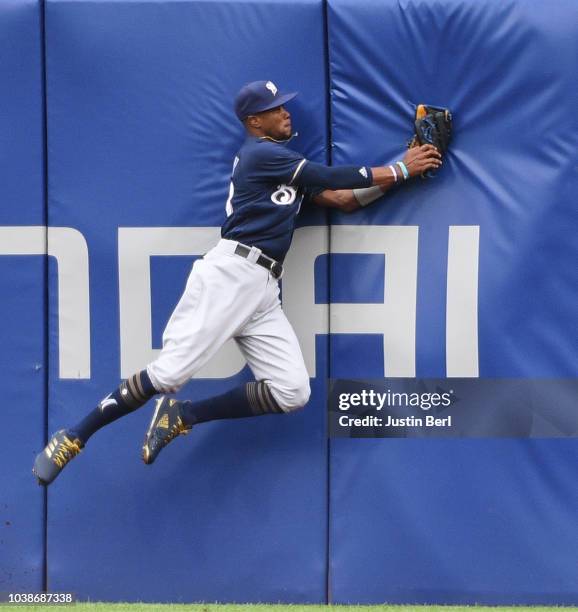 Keon Broxton of the Milwaukee Brewers makes a catch at the wall on a ball off the bat of Pablo Reyes of the Pittsburgh Pirates in the eighth inning...