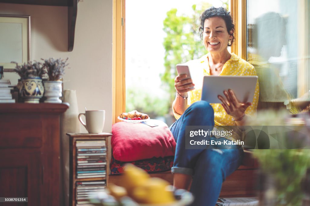 Mature woman is purchasing online at home