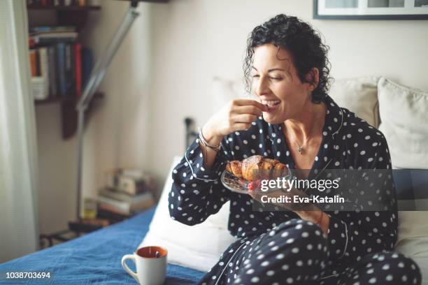 mature woman is having a french breakfast at home - hungary hotel stock pictures, royalty-free photos & images