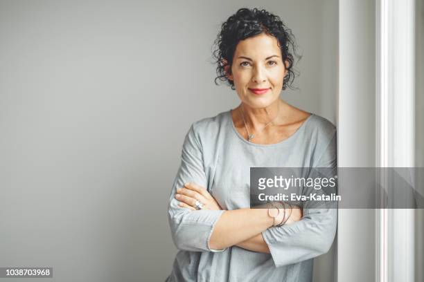 portrait of a confident businesswoman - mid adult women stock pictures, royalty-free photos & images