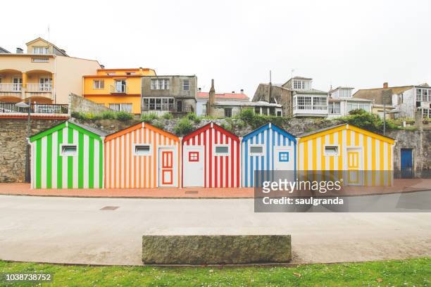 colorful beach huts against the old village - blue house red door stock pictures, royalty-free photos & images