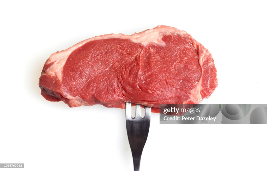 Raw steak on a fork