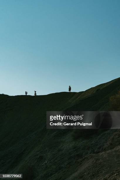 people walking on top of hills - malta wandern stock-fotos und bilder