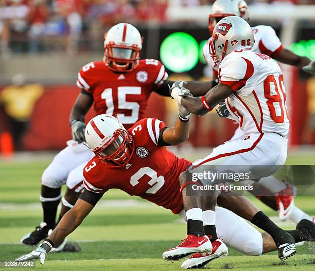 Willie McNeal of the Western Kentucky Hilltoppers trys to avoid being brought down by Ricky Thenarse of the Nebraska Cornhuskers during first half...