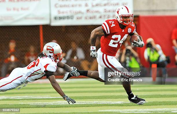 Jamal Forest of the Western Kentucky Hilltoppers tries to bring down Niles Paul of the Nebraska Cornhuskers during first half action of their game at...