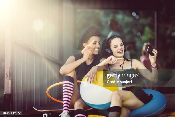 group of teenagers hanging out - smartphones dangling stock pictures, royalty-free photos & images