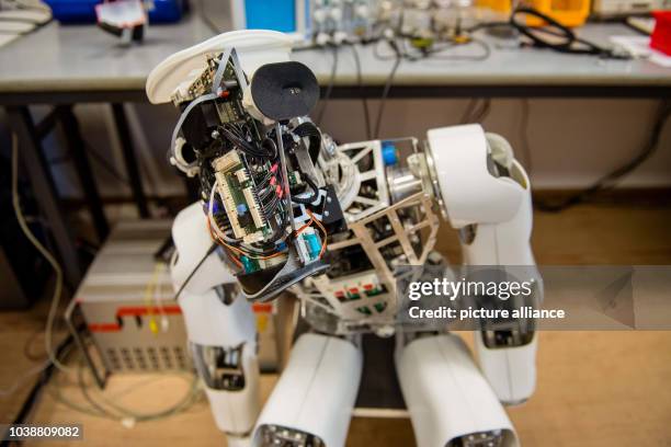 Deactivated 'Myon' roboter that has been partly demounted for maintenance purposes lies in a corner of the research laboratory for new-robotics at...