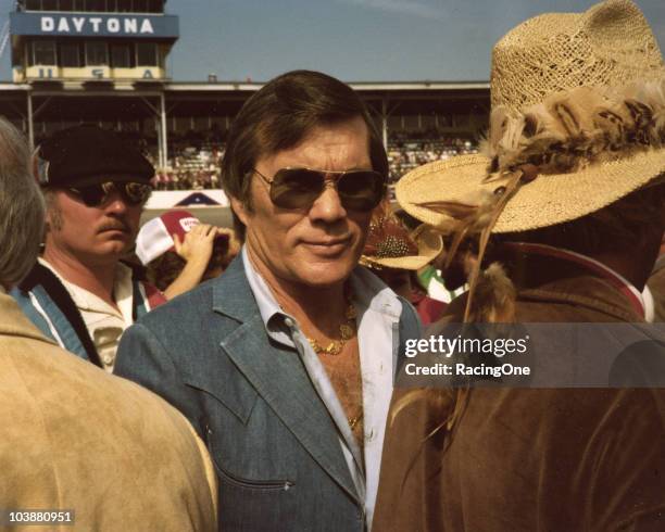 Film director and stuntman Hal Needham enjoys pre-race activities before a NASCAR race at Daytona International Speedway. Needham was a successful...