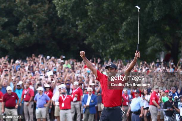 Tiger Woods of the United States celebrates making a par on the 18th green to win the TOUR Championship at East Lake Golf Club on September 23, 2018...