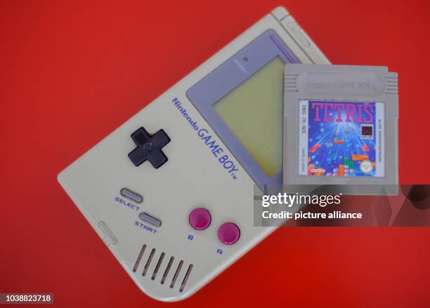 An illustrated picture shows a first generation Game Boy and the video game Tetris lying on a table in Dresden, Germany, 28 April 2014. Photo: Thomas...