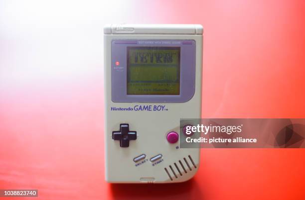An illustrated picture shows a first generation Game Boy with the video game Tetris lying on a table in Dresden, Germany, 28 April 2014. Photo:...