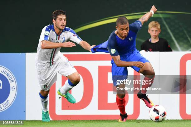 Italy's Davide Vitturini and France's Kylian Mbappe vie for the ball during the UEFA European Under-19 Championship final soccer match between France...