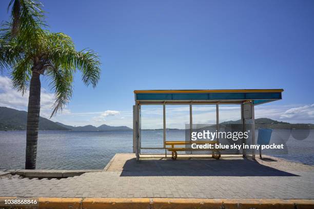 a modern bus shelter with picture windows. lagoa da conceição, florianopolis, brazil. - bus shelter ストックフォトと画像