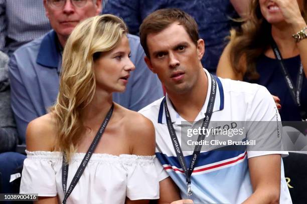 Tennis player Mike Bryan of the United States and model Nadia Murgasova of Slovakia watch the Men's Singles match between Team Europe Alexander...