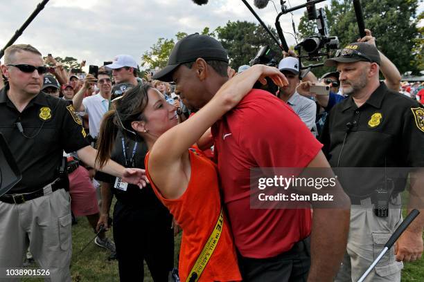 Tiger Woods and his girlfriend Erica Herman celebrate after the final round of the TOUR Championship at East Lake Golf Club on September 23 in...