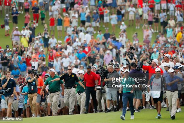 Tiger Woods of the United States walks to the 18th green during the final round of the TOUR Championship at East Lake Golf Club on September 23, 2018...
