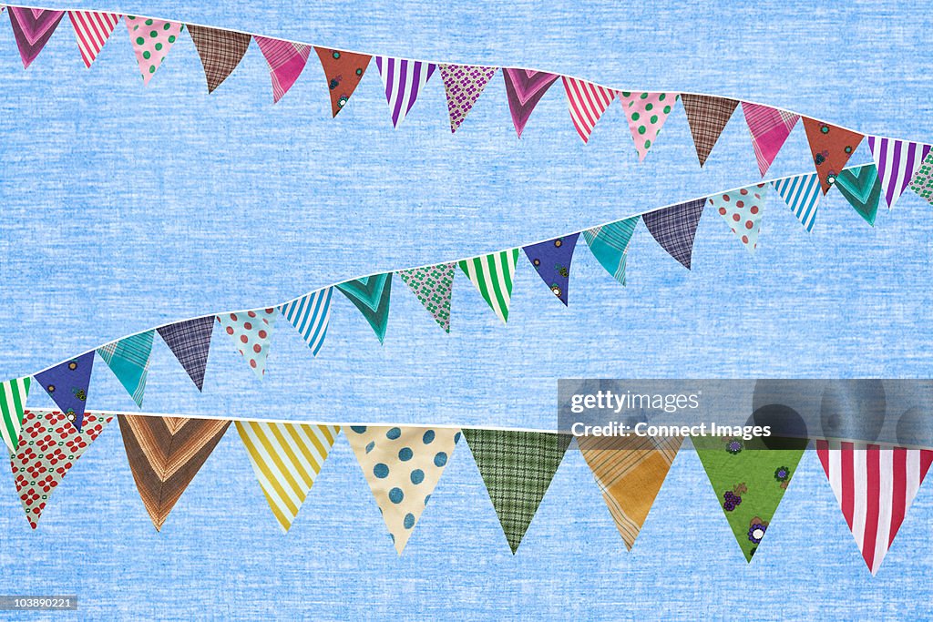 Multi coloured bunting against blue background