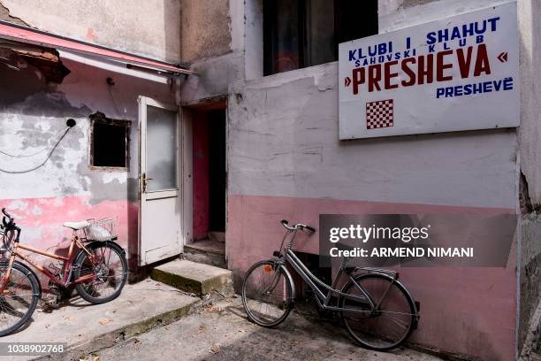 Cycles stand parked in front of Chess Club "Presheva" in the southern Serbian town of Presevo on September 12, 2018. - In the border valley of...