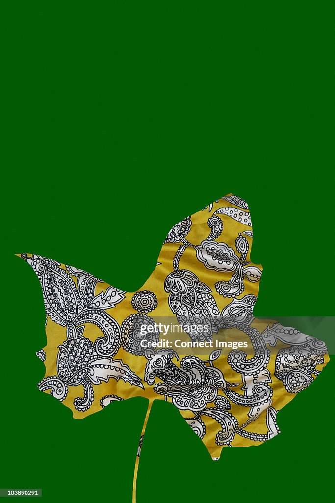 Paisley maple leaf on green background