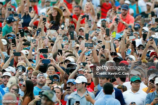 Fans take pictures of Tiger Woods of the United States during the final round of the TOUR Championship at East Lake Golf Club on September 23, 2018...