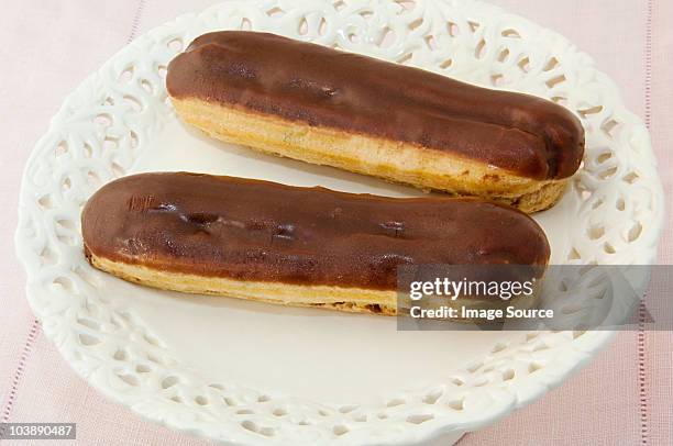 two chocolate eclairs - eclair stockfoto's en -beelden